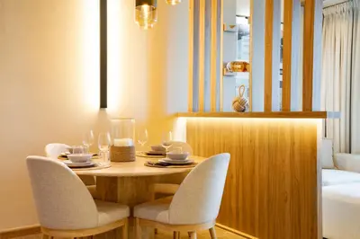 a dining room table with two chairs and a table with glasses at Modern and Stylish 2-BR High Floor All Bills Included in Dubai