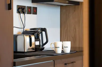 a kitchen with two coffee cups on a counter at Modern and Stylish 2-BR High Floor All Bills Included in Dubai