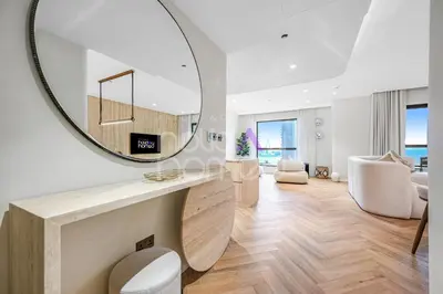 a living room with a large mirror on the wall at Modern 1BR JBR Stunning Sea & Ain Dubai Views in Dubai