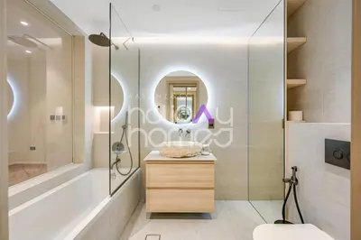 a bathroom with a sink and a shower and a mirror at Modern 1BR JBR Stunning Sea & Ain Dubai Views in Dubai