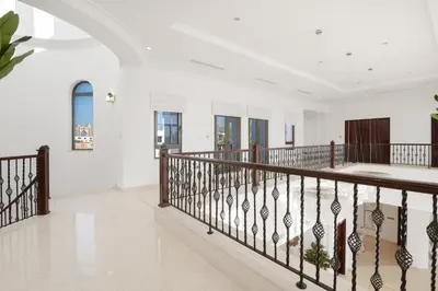 a staircase in a house with white walls at Maison Privee - Villa on Beach with Private Pool The Palm Jumeirah in Dubai