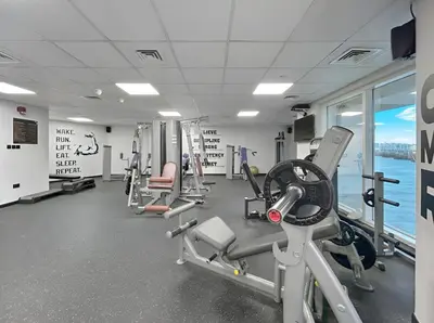 a gym with treadmills and machines in a building at Sunny Studio with Pool, Gym & Sauna in Dubai Escape in Dubai