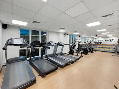 a gym with treadmills and elliptical machines at Sunny Studio with Pool, Gym & Sauna in Dubai Escape in Dubai
