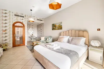 a bedroom with a large bed in a room at Sunny Studio with Pool, Gym & Sauna in Dubai Escape in Dubai