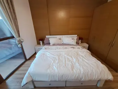 a bedroom with a bed with white sheets and pillows at Modern One-Bedroom Apartment King and Queen Beds Two Bathrooms in Dubai