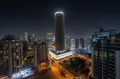 a city skyline at night with a tall building at Tranquil 1BR with Private Plunge Pool in Dubai