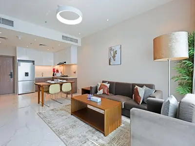 a living room with a couch and a table at Bright & Spacious 2-Bedroom Apartment Al furjan-706 in Dubai