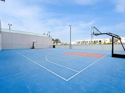 an empty basketball court with a basketball hoop at Bright & Spacious 2-Bedroom Apartment Al furjan-706 in Dubai