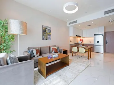 a living room with a couch and a table at Comfortable 2-Bedroom Home in Al Furjan-607 in Dubai