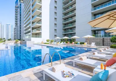 an image of a swimming pool at a hotel at Luxury Apt Canal View - 5min Burj & Dubai Mall in Dubai
