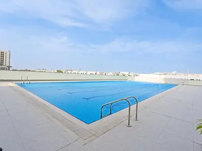 a large swimming pool with blue water in a building at Modern 1-Bedroom Apartment in Sepcoo Residence-1005 in Dubai