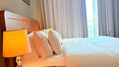 a bedroom with a bed with pillows and a window at Ready-to-Move 1-Bedroom in Al Furjan-103 in Dubai