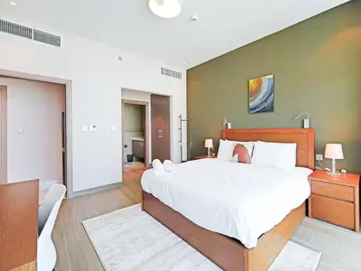 a bedroom with a large bed in a room at Spacious 2-Bedroom Apartment in Al Furjan-1010 in Dubai