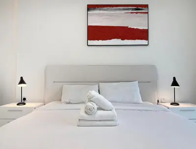 a white bed with a towel on top of it at Premium Luxury 2BR Business Bay - Valet parking, Pool, Gym, SPA and Ice room in Dubai