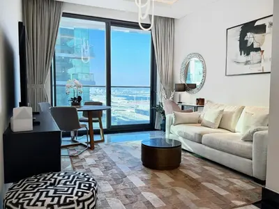 a living room with a couch and a table at Premium Luxury 2BR Business Bay - Valet parking, Pool, Gym, SPA and Ice room in Dubai