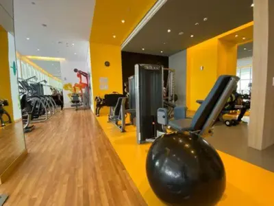 a fitness room with a gym with exercise equipment at Vogue JVT Novotel Near Springs Souk Mall, One Bedroom Apartment with Large Balcony and Vibrant Community view, Access to all Amenities in Dubai