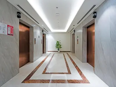 a corridor of an office building with a potted plant at Well-Maintained 2-Bedroom Apartment Al Furjan-207 in Dubai