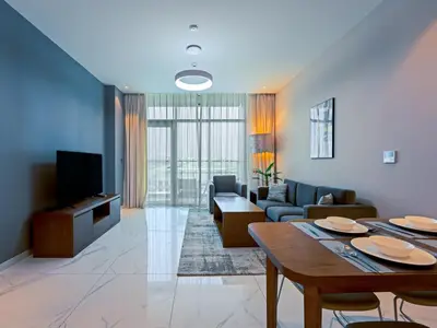 a living room with a couch and a table at Well-Maintained 2-Bedroom Home in Community-410 in Dubai