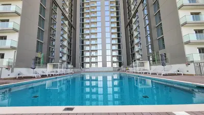 a swimming pool in front of two tall buildings at STAY BY LATINEM Luxury 1BR Holiday Home CVR A 1410 near Downtown in Dubai
