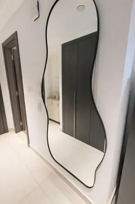 a mirror hanging on a wall in a room at Extra-Large Studio l AG Tower l Business Bay in Dubai