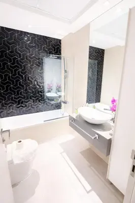 a bathroom with two sinks and a toilet and a mirror at Extra-Large Studio l AG Tower l Business Bay in Dubai