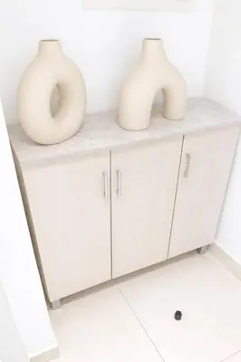 three white vases sitting on top of a shelf at Extra-Large Studio l AG Tower l Business Bay in Dubai