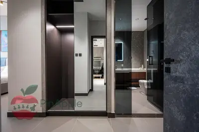 a bathroom with a glass door with an apple on it at High Floor With Full Lake View in Dubai