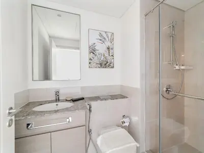 a bathroom with a toilet and a sink and a shower at Brand New & Welcoming 2BDR In Forte Downtown 34 in Dubai