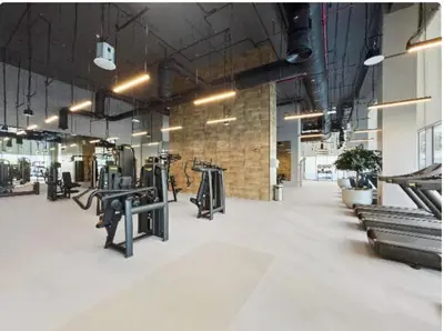 a gym with rows of benches and a brick wall at Brand New & Welcoming 2BDR In Forte Downtown 34 in Dubai