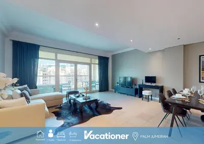 a living room with a couch and a table at Vacationer l 1 Bed on The Palm l City Views l Near Atlantis in Dubai