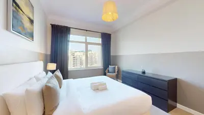 a bedroom with a white bed and a window at Vacationer l 1 Bed on The Palm l City Views l Near Atlantis in Dubai