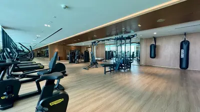 a gym with treadmills and exercise equipment in a building at Cozy Studio with Balcony and Jacuzzi I Near Dubai Mall & Downtown I Sleeps 4 in Dubai