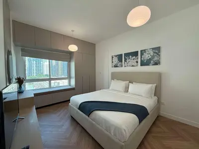 a bedroom with a large bed and a window at High End Upgraded 1BR Living in The Greens in Dubai