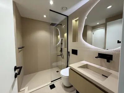 a bathroom with a toilet and a shower and a sink at High End Upgraded 1BR Living in The Greens in Dubai