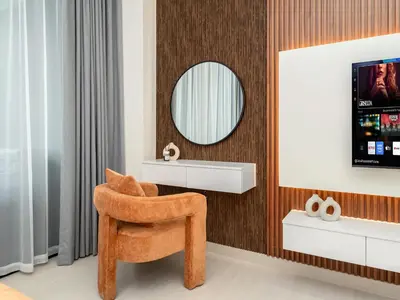 a bathroom with a orange chair and a mirror at Amazing Studio with Balcony and Jacuzzi I Near Dubai Mall & Downtown I Sleeps 4 in Dubai