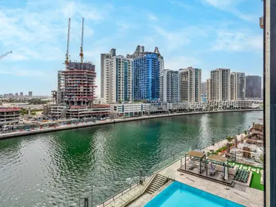 a view of a river in a city with buildings at Amazing Studio with Balcony and Jacuzzi I Near Dubai Mall & Downtown I Sleeps 4 in Dubai