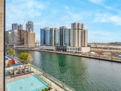 a view of a city with a river and buildings at Amazing Studio with Balcony and Jacuzzi I Near Dubai Mall & Downtown I Sleeps 4 in Dubai