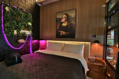 a bedroom with a bed with a painting and purple lights at The Eden Suite Modern Luxury Meets Cozy Comfort in Dubai