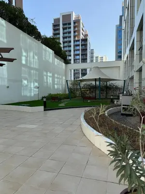 a courtyard in a building with a table and umbrella at Fully Luxury Studio Total Privacy Pool & Sauna in Dubai