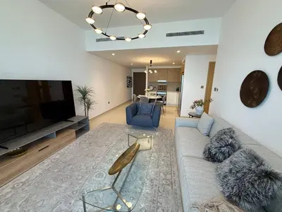 a living room with a couch and a tv at 17 Icon Bay Creek Harbour in Dubai