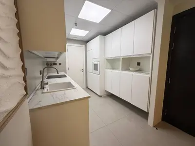 a kitchen with white cabinets and a sink at The Point Tower Dubai Marina in Dubai