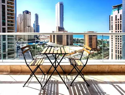 a table and chairs on a balcony with a view of a city at Penthouse with panoramic water-view Ultra-luxury in Dubai