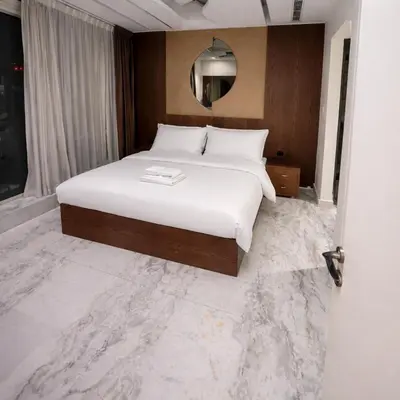 a bedroom with a large white bed and a mirror at Penthouse with panoramic water-view Ultra-luxury in Dubai