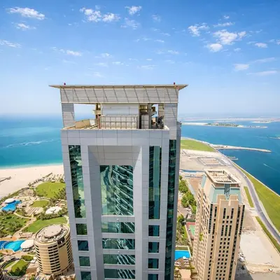 a building with a balcony on top of it next to the ocean at Penthouse with panoramic water-view Ultra-luxury in Dubai