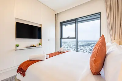 a bedroom with a large bed with a large window at Superhost - 1BR Apartment , Pool & Gym , Near Dubai Hills Mall in Dubai