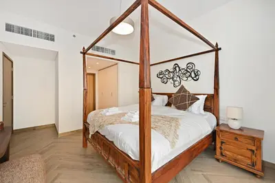 a bedroom with a canopy bed with white sheets at Bloomfields Luxurious 3BR in West Residences in Dubai