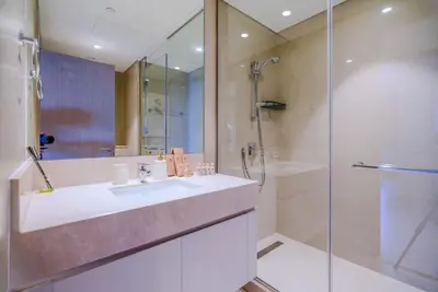 a bathroom with a sink and a shower at TRPS - Act Towers, Downtown Dubai - Full Burj Khalifa View, High-End 3BR plus Maids in Dubai