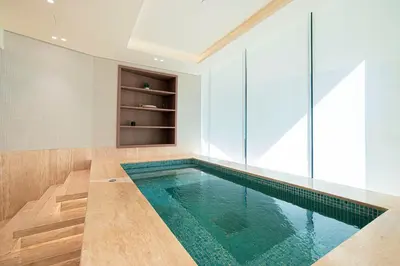 a swimming pool in a room with glass walls at Iconic Binghatti Royale! Private Pool in Your Balcony! 5 Star Amenities! in Dubai