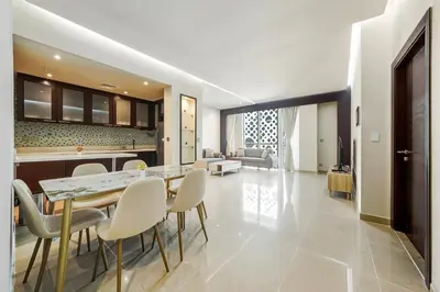 a kitchen and dining room with a table and chairs at Modern Smart & Spacious 1BR Business Bay near Downtown Dubai in Dubai