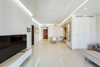 a living room with a couch and a tv at Modern Smart & Spacious 1BR Business Bay near Downtown Dubai in Dubai